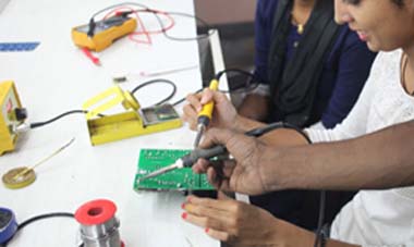 Soldering technician soldering PCBs